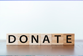 wooden blocks that spell "Donate" 